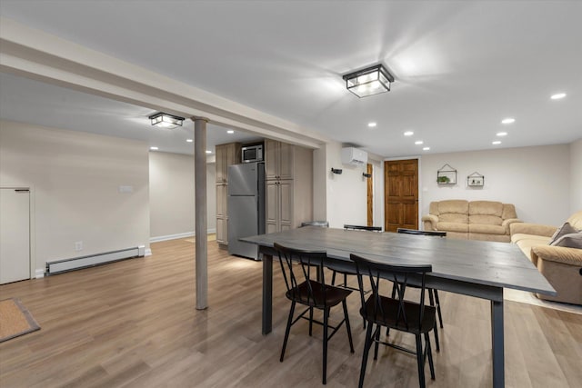 2854 Lenox Rd, Oceanside, NY 11572 - dining space with a baseboard radiator, a wall unit AC, recessed lighting, and light wood-style floors