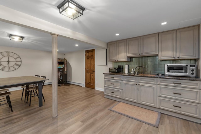 2854 Lenox Rd, Oceanside, NY 11572 - kitchen with baseboard heating, light wood finished floors, decorative backsplash, gray cabinets, and recessed lighting