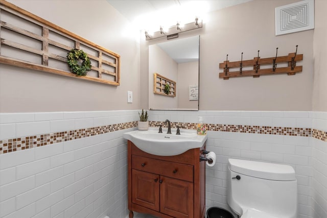 2854 Lenox Rd, Oceanside, NY 11572 - half bathroom featuring tile walls, vanity, and wainscoting