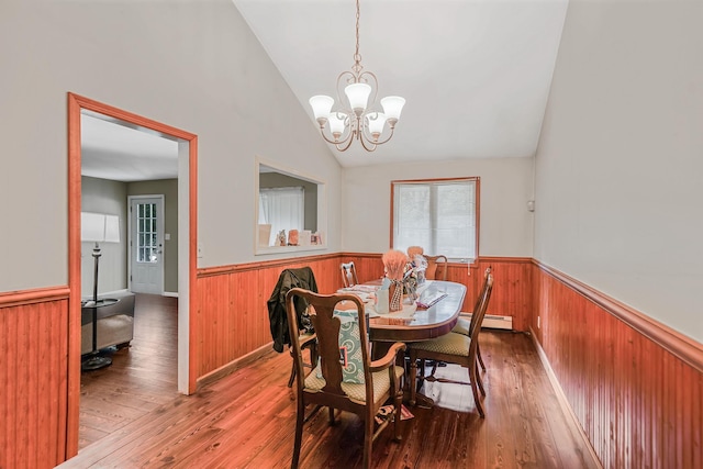 436 Oceanside St, Islip Terrace, NY 11752 - dining room with wainscoting, a chandelier, wood finished floors, vaulted ceiling, and wood walls