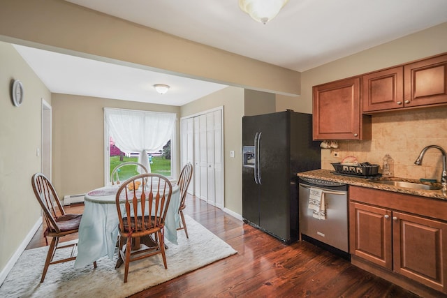 436 Oceanside St, Islip Terrace, NY 11752 - kitchen featuring dishwasher, black fridge, a baseboard heating unit, decorative backsplash, and brown cabinetry
