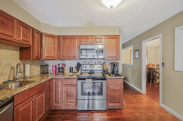 436 Oceanside St, Islip Terrace, NY 11752 - kitchen with appliances with stainless steel finishes, light stone counters, backsplash, and dark wood finished floors