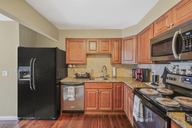 436 Oceanside St, Islip Terrace, NY 11752 - kitchen featuring appliances with stainless steel finishes, light stone countertops, dark wood-style floors, and decorative backsplash