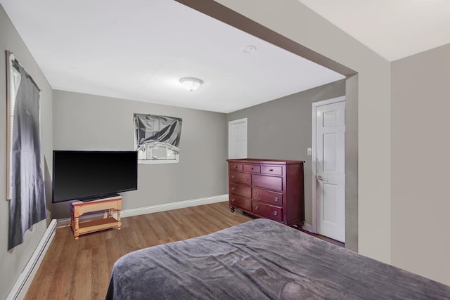 436 Oceanside St, Islip Terrace, NY 11752 - bedroom featuring a baseboard radiator and wood finished floors