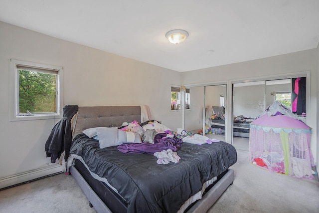 436 Oceanside St, Islip Terrace, NY 11752 - carpeted bedroom featuring two closets, multiple windows, and baseboard heating