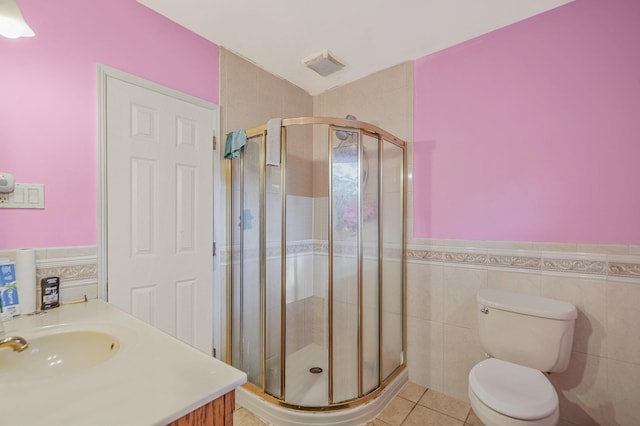 436 Oceanside St, Islip Terrace, NY 11752 - bathroom with tile walls, a shower stall, tile patterned floors, wainscoting, and vanity