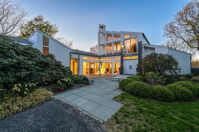 4105 Soundview Ave, Mattituck, NY 11952 - back of property at dusk with a balcony