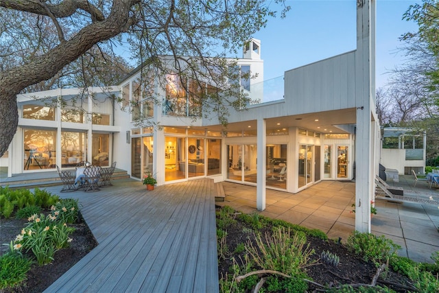 4105 Soundview Ave, Mattituck, NY 11952 - rear view of property featuring a wooden deck, a patio, and a chimney