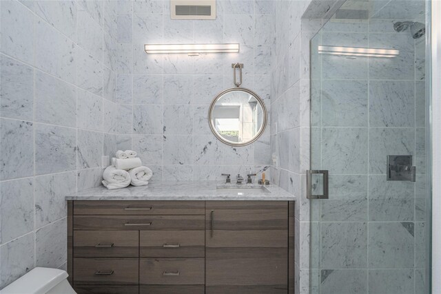 4105 Soundview Ave, Mattituck, NY 11952 - bathroom featuring tile walls, vanity, and a stall shower