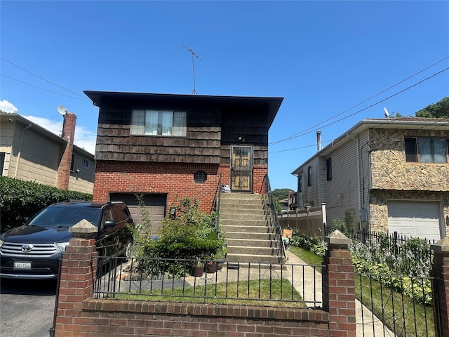 8 Bainbridge St, Roosevelt, NY 11575 - tri-level home with an attached garage and brick siding