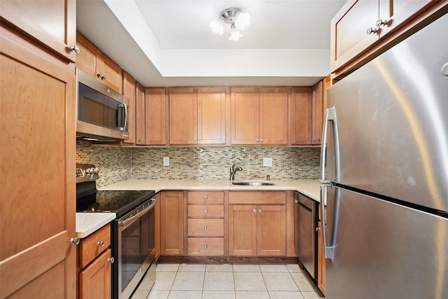 52 Jefferson Oval Unit E, Yorktown Heights, NY 10598 - kitchen with stainless steel appliances, light tile patterned flooring, backsplash, and light countertops