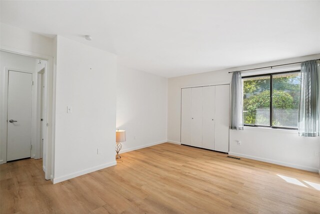 52 Jefferson Oval Unit E, Yorktown Heights, NY 10598 - unfurnished bedroom featuring light wood finished floors and a closet