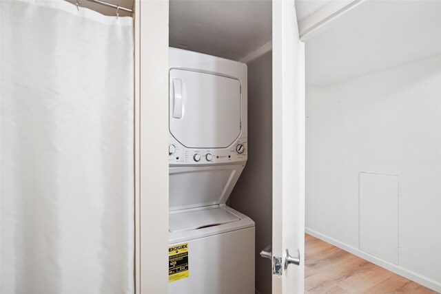 52 Jefferson Oval Unit E, Yorktown Heights, NY 10598 - laundry area featuring stacked washer and clothes dryer and wood finished floors
