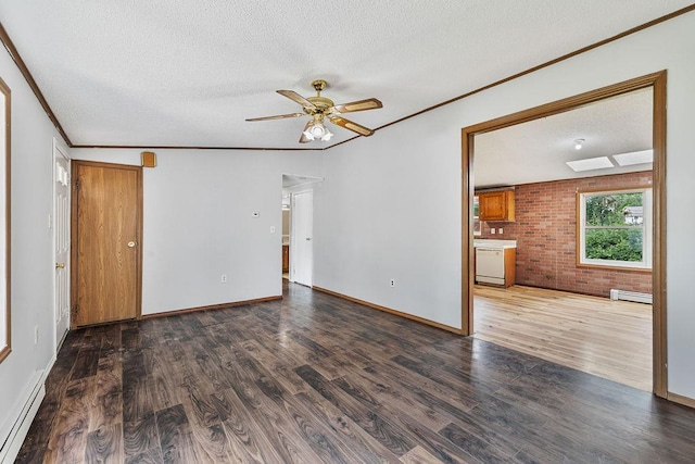 14 Cooper Dr, Nanuet, NY 10954 - empty room featuring baseboard heating, ceiling fan, wood finished floors, brick wall, and crown molding