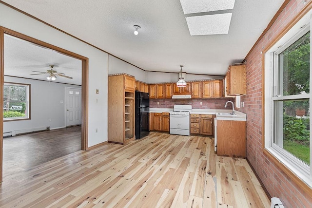 14 Cooper Dr, Nanuet, NY 10954 - kitchen featuring freestanding refrigerator, white range, brown cabinetry, light countertops, and light wood-type flooring
