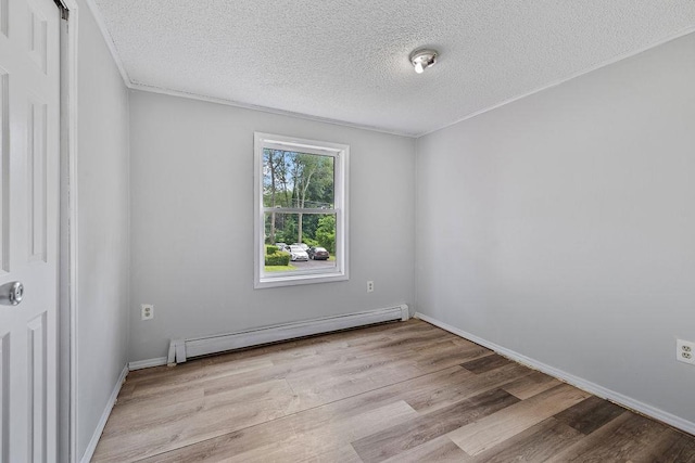 14 Cooper Dr, Nanuet, NY 10954 - spare room with baseboard heating, a textured ceiling, and wood finished floors