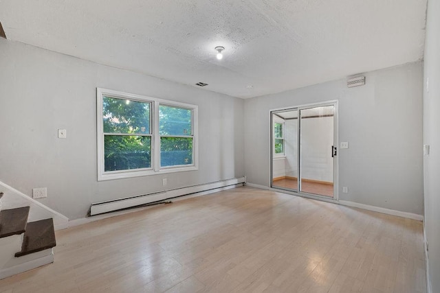 14 Cooper Dr, Nanuet, NY 10954 - spare room featuring a baseboard radiator, a textured ceiling, wood finished floors, and stairs