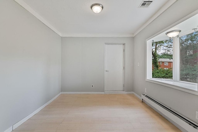 14 Cooper Dr, Nanuet, NY 10954 - empty room featuring a baseboard heating unit, light wood-style flooring, and crown molding