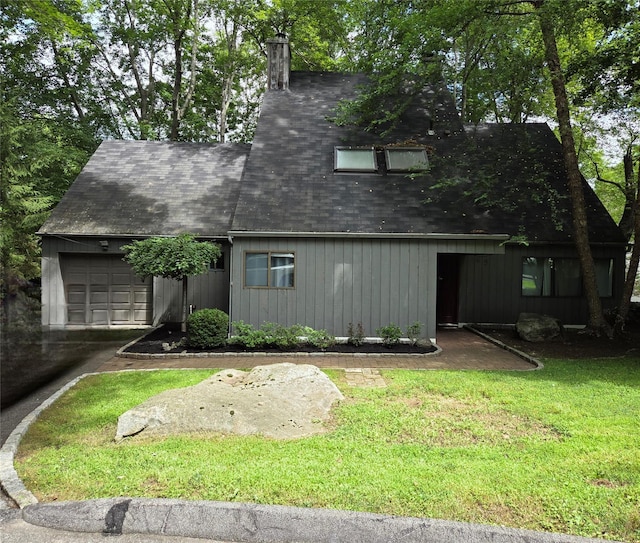 69 Mitchell Rd, Somers, NY 10589 - view of front of property with an attached garage, a chimney, a shingled roof, a front yard, and driveway