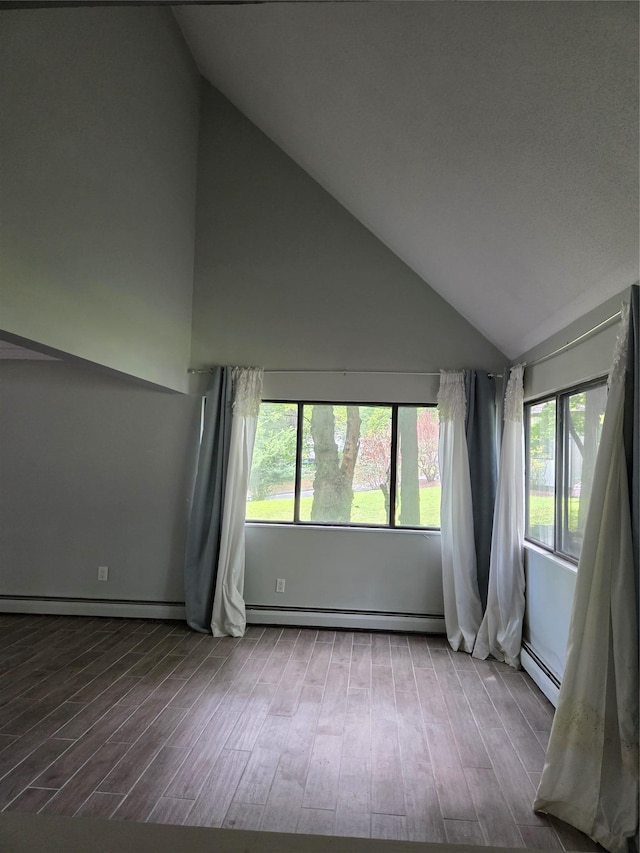 69 Mitchell Rd, Somers, NY 10589 - spare room featuring a baseboard radiator, vaulted ceiling, plenty of natural light, and wood finished floors