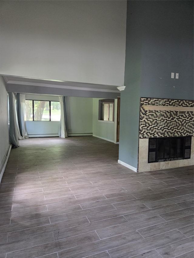 69 Mitchell Rd, Somers, NY 10589 - unfurnished living room featuring a towering ceiling, a fireplace, and wood finished floors