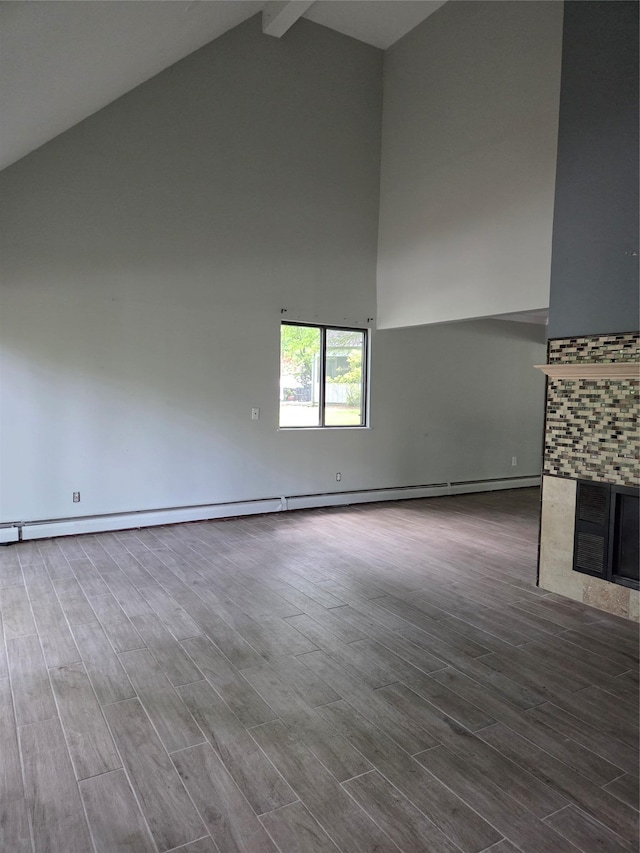 69 Mitchell Rd, Somers, NY 10589 - unfurnished living room featuring high vaulted ceiling, a fireplace, beam ceiling, wood finished floors, and baseboard heating