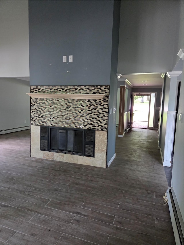 69 Mitchell Rd, Somers, NY 10589 - kitchen with a high ceiling, a tile fireplace, a baseboard heating unit, and dark wood-style flooring