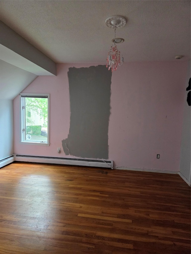 69 Mitchell Rd, Somers, NY 10589 - additional living space featuring wood finished floors, vaulted ceiling, a textured ceiling, and a baseboard radiator