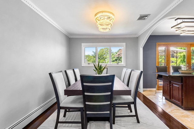 184 Overlook Dr, East Islip, NY 11730 - dining room featuring a baseboard radiator, a chandelier, ornamental molding, arched walkways, and light wood-style floors