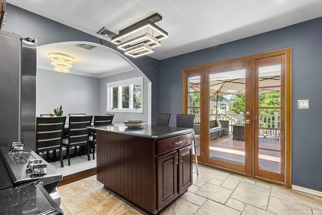 184 Overlook Dr, East Islip, NY 11730 - office space with stone tile flooring, crown molding, arched walkways, and a chandelier