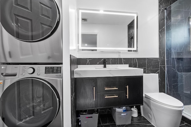 184 Overlook Dr, East Islip, NY 11730 - full bathroom with stacked washer / dryer, tile walls, and vanity