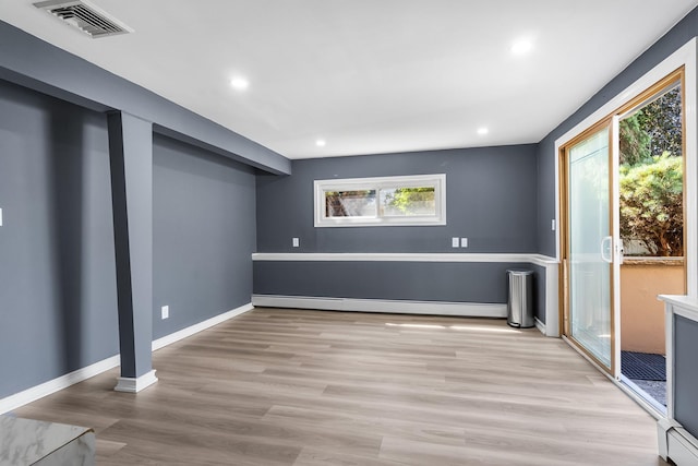 184 Overlook Dr, East Islip, NY 11730 - basement featuring baseboard heating, wood finished floors, and recessed lighting