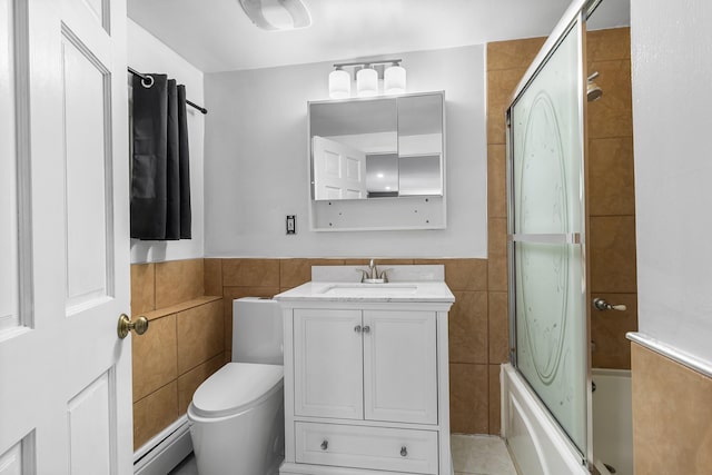 184 Overlook Dr, East Islip, NY 11730 - full bathroom featuring a baseboard radiator, tile walls, vanity, shower / washtub combination, and wainscoting