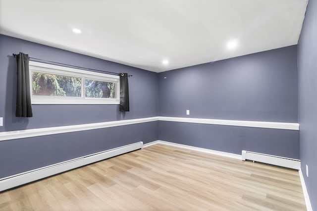 184 Overlook Dr, East Islip, NY 11730 - spare room featuring a baseboard radiator, wood finished floors, and recessed lighting