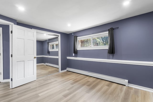 184 Overlook Dr, East Islip, NY 11730 - spare room featuring baseboard heating, wood finished floors, and recessed lighting