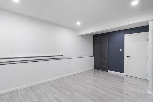 184 Overlook Dr, East Islip, NY 11730 - empty room with a baseboard heating unit and recessed lighting