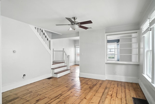 14 Washington Ave, Port Jervis, NY 12771 - unfurnished living room featuring light wood-type flooring, stairway, and healthy amount of natural light