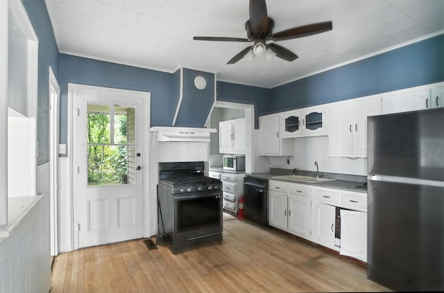 14 Washington Ave, Port Jervis, NY 12771 - kitchen featuring black appliances, ventilation hood, a ceiling fan, white cabinets, and light wood-style floors