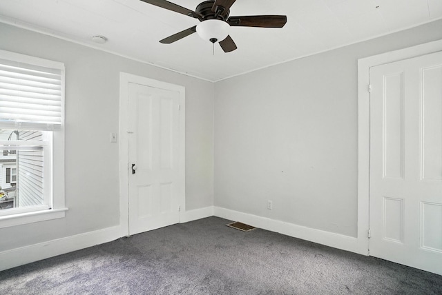 14 Washington Ave, Port Jervis, NY 12771 - empty room with dark carpet, plenty of natural light, and ceiling fan