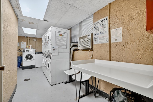 4295 Webster Ave Unit 5J, Bronx, NY 10470 - community laundry featuring stacked washer / dryer, a textured wall, and a wall mounted AC