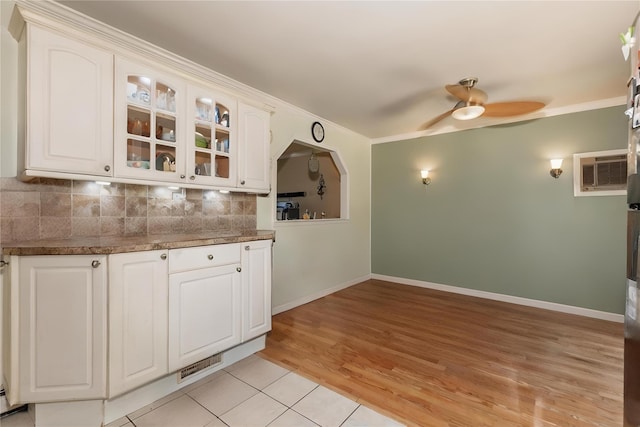 1191 E 3rd Ave, Bay Shore, NY 11706 - kitchen with a ceiling fan, a wall mounted AC, glass insert cabinets, white cabinetry, and crown molding