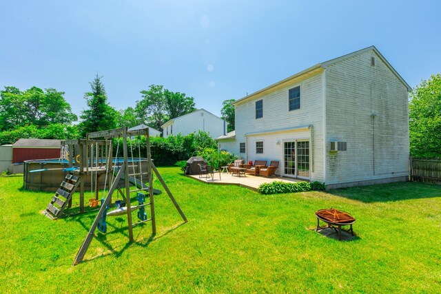1191 E 3rd Ave, Bay Shore, NY 11706 - rear view of house featuring a patio, an outdoor pool, a playground, and an outdoor living space with a fire pit