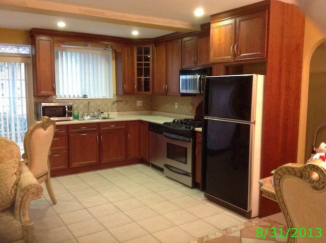 8502 57th Rd, Elmhurst, NY 11373 - kitchen with stainless steel appliances, tasteful backsplash, light countertops, healthy amount of natural light, and recessed lighting