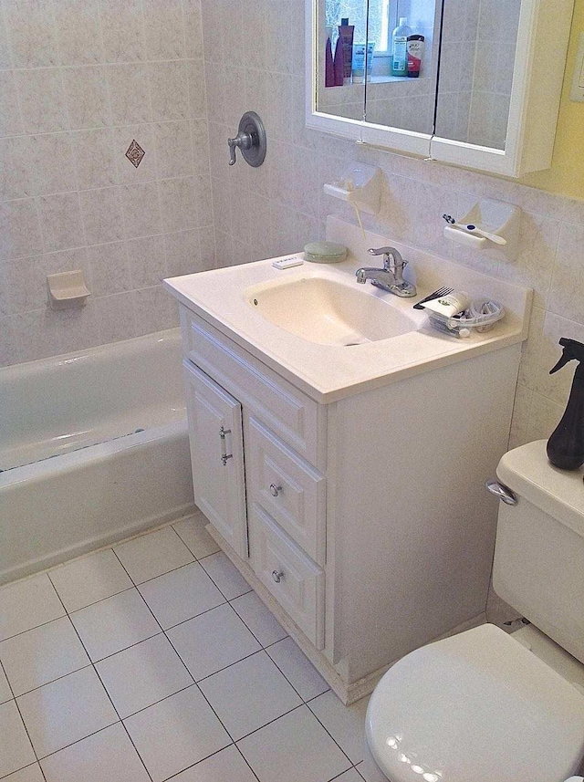 8502 57th Rd, Elmhurst, NY 11373 - full bath featuring tile walls, tile patterned flooring, vanity, and washtub / shower combination