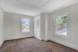 10 Valentine St, Glen Cove, NY 11542 - empty room with baseboards and carpet floors