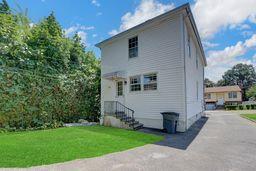 10 Valentine St, Glen Cove, NY 11542 - back of property featuring a lawn