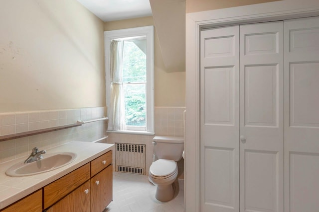 165 River Rd, Nyack, NY 10960 - bathroom featuring radiator, a closet, tile walls, vanity, and healthy amount of natural light
