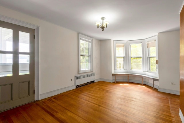 165 River Rd, Nyack, NY 10960 - entrance foyer with radiator, light wood-type flooring, and a chandelier