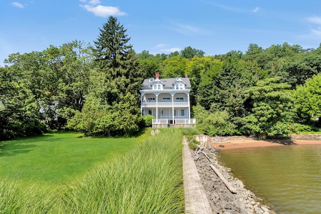 165 River Rd, Nyack, NY 10960 - back of house with a balcony, a chimney, a wooded view, a water view, and a yard