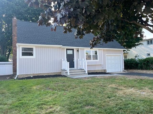 123 Buffalo Ave, Lindenhurst, NY 11757 - view of front facade featuring a chimney, board and batten siding, roof with shingles, and a garage
